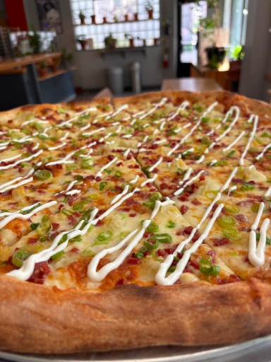 A standard cheese pizza with sliced portions.