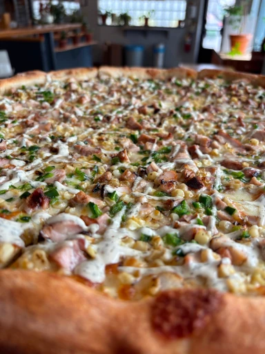 A standard cheese pizza with sliced portions.