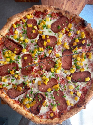 A standard cheese pizza with sliced portions.